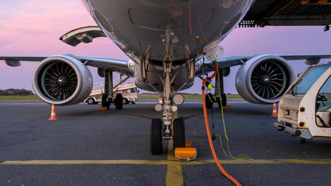 Passenger aircraft on an apron, viewed beneath its nose